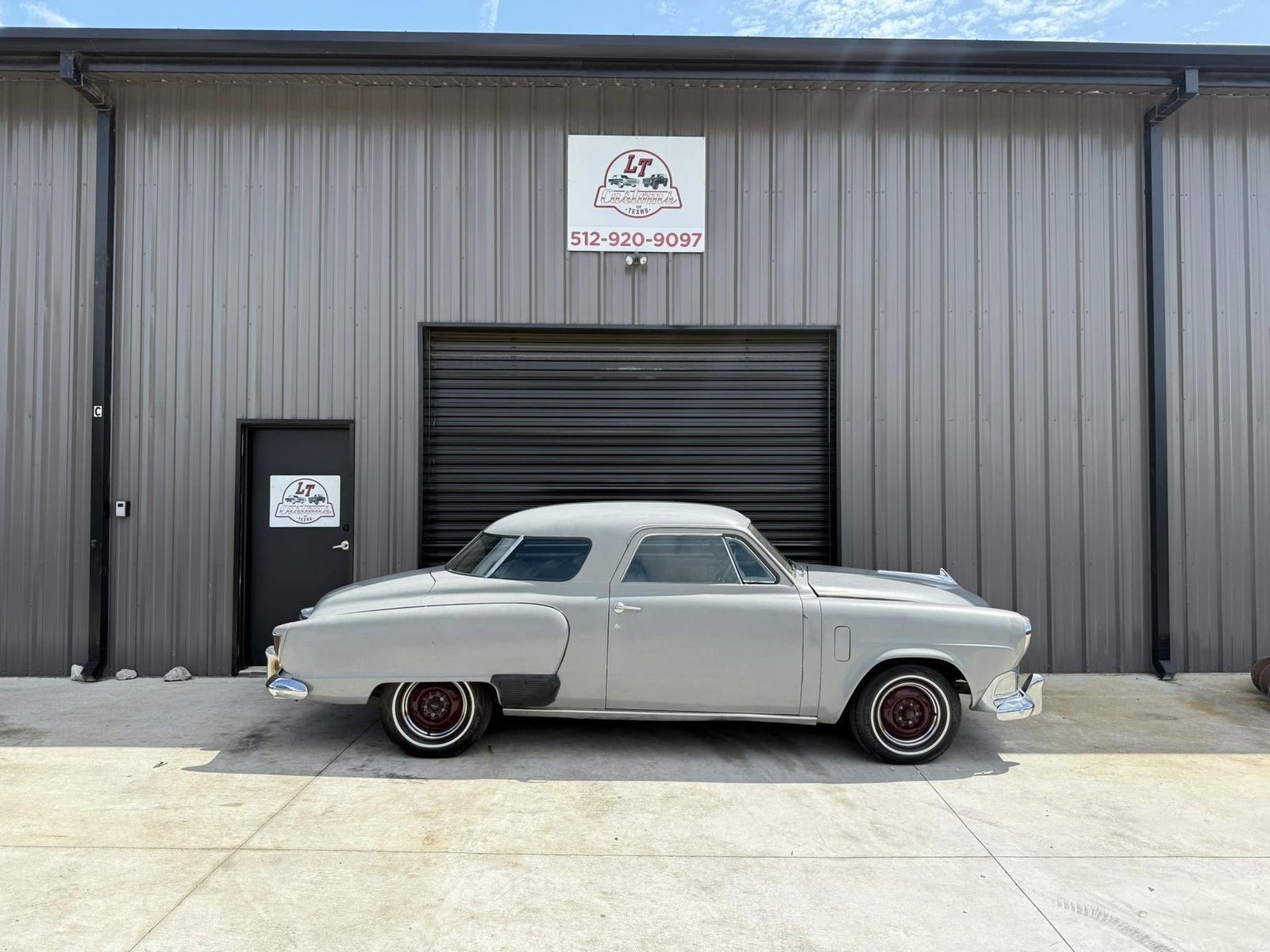 1950s coupe in front of the shop